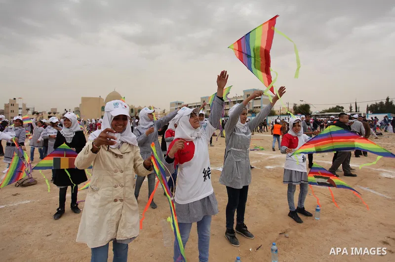 Palestinian children fly kites to show their solidarity with the Japanese people near the Japan-funded housing project in Khan Younis in the southern Gaza Strip March 13, 2016. The event was organised by the United Natio...