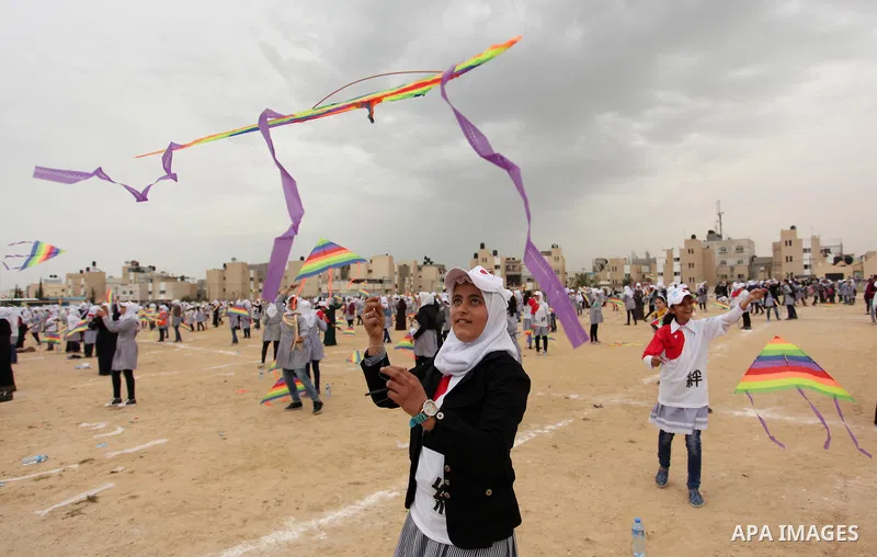 Palestinian children fly kites to show their solidarity with the Japanese people near the Japan-funded housing project in Khan Younis in the southern Gaza Strip March 13, 2016. The event was organised by the United Natio...