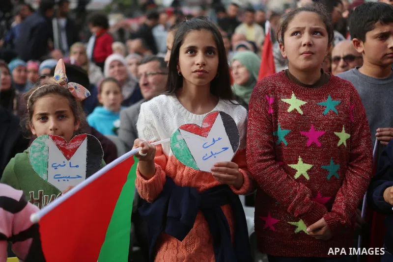 Palestinians celebrate in the West Bank city of Ramallah March 13, 2016 after primary school teacher Hanan al-Hroub won the Million Dollar Teacher award. Al-Hroub travelled from the West Bank to Dubai, where on Sunday th...