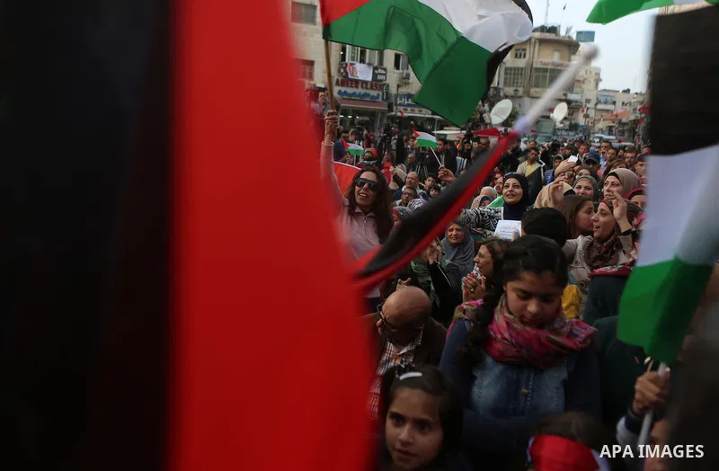 Palestinians celebrate in the West Bank city of Ramallah March 13, 2016 after primary school teacher Hanan al-Hroub won the Million Dollar Teacher award. Al-Hroub travelled from the West Bank to Dubai, where on Sunday th...