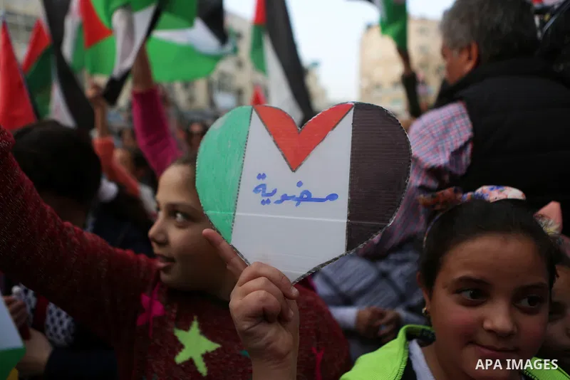 Palestinians celebrate in the West Bank city of Ramallah March 13, 2016 after primary school teacher Hanan al-Hroub won the Million Dollar Teacher award. Al-Hroub travelled from the West Bank to Dubai, where on Sunday th...