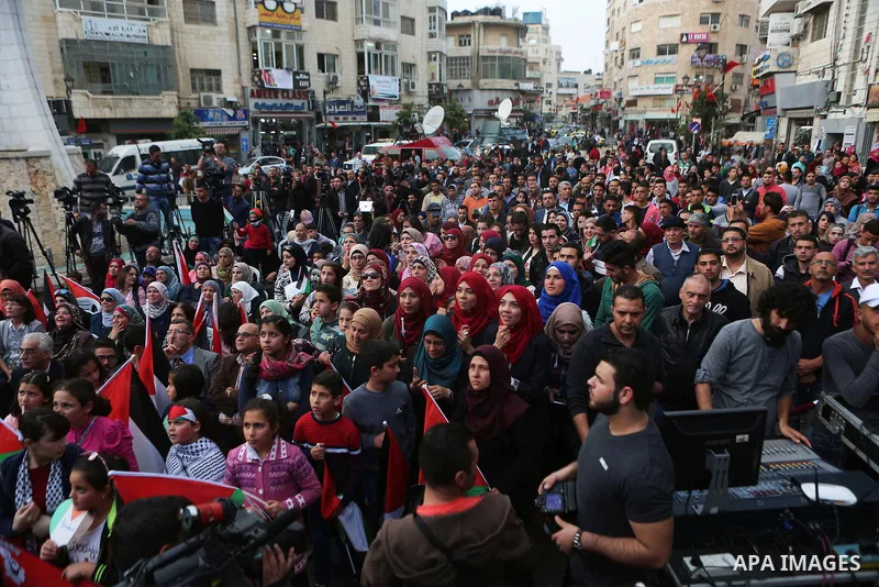 Palestinians celebrate in the West Bank city of Ramallah March 13, 2016 after primary school teacher Hanan al-Hroub won the Million Dollar Teacher award. Al-Hroub travelled from the West Bank to Dubai, where on Sunday th...