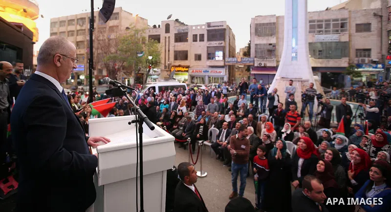 Palestinian Prime Minister, celebrates in the West Bank city of Ramallah March 13, 2016 after primary school teacher Hanan al-Hroub won the Million Dollar Teacher award. Al-Hroub travelled from the West Bank to Dubai, wh...