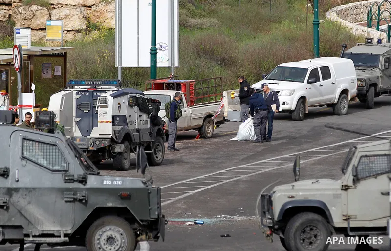 Israeli security forces gather at the scene of what the Israeli military said were back-to-back gun and car-ramming attacks by Palestinians, near the Jewish settlement of Kiryat Arba near the West Bank city of Hebron Mar...