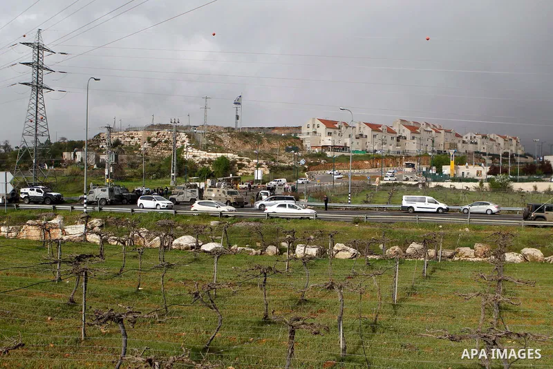 Israeli security forces gather at the scene of what the Israeli military said were back-to-back gun and car-ramming attacks by Palestinians, near the Jewish settlement of Kiryat Arba near the West Bank city of Hebron Mar...