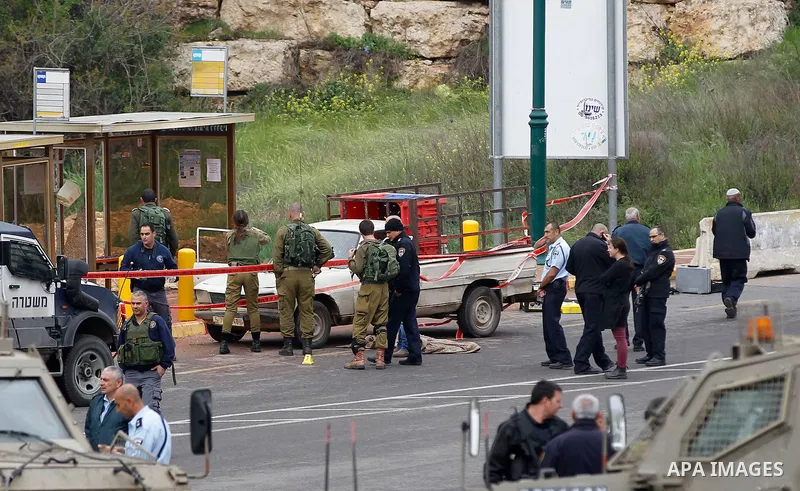 Israeli security forces gather at the scene of what the Israeli military said were back-to-back gun and car-ramming attacks by Palestinians, near the Jewish settlement of Kiryat Arba near the West Bank city of Hebron Mar...