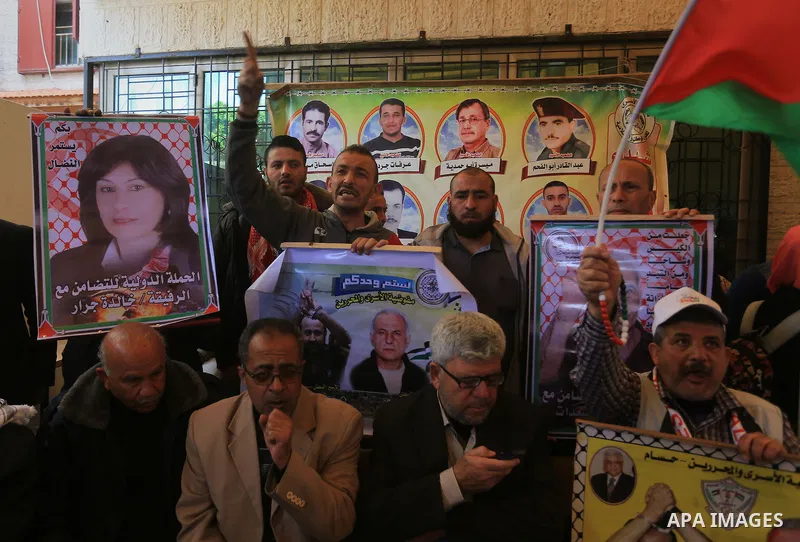 Palestinians take part in a protest demanding release the prisoners in Israeli jails, in front of Red cross office, in Gaza city, on March 14, 2016. Photo by Yasser Qudih