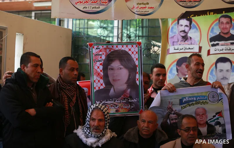 Palestinians take part in a protest demanding release the prisoners in Israeli jails, in front of Red cross office, in Gaza city, on March 14, 2016. Photo by Yasser Qudih