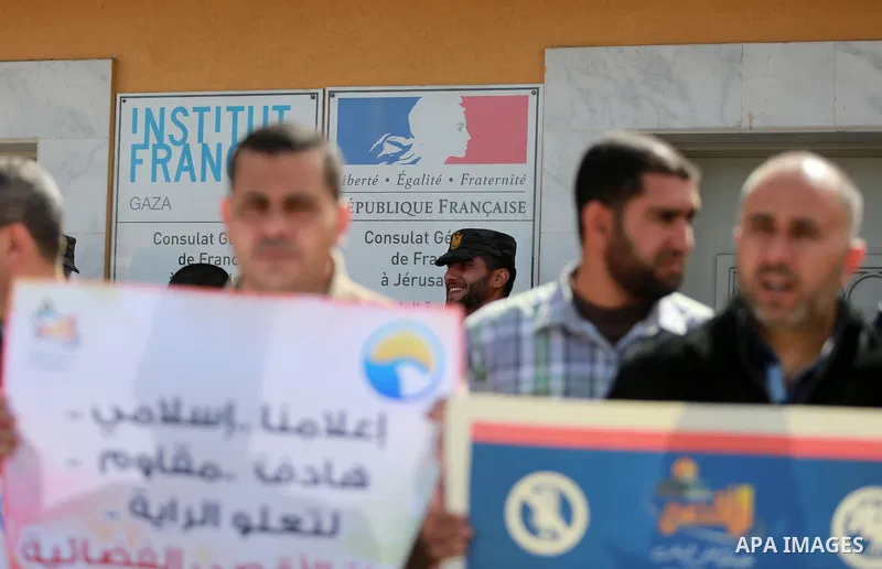Palestinian journalists hold placards during a protest to solidarity with al-Aqsa TV channel which it removing from EUTELSAT, in Gaza City on March 14, 2016. Israeli Prime Minister Benjamin Netanyahu said Sunday that Isr...