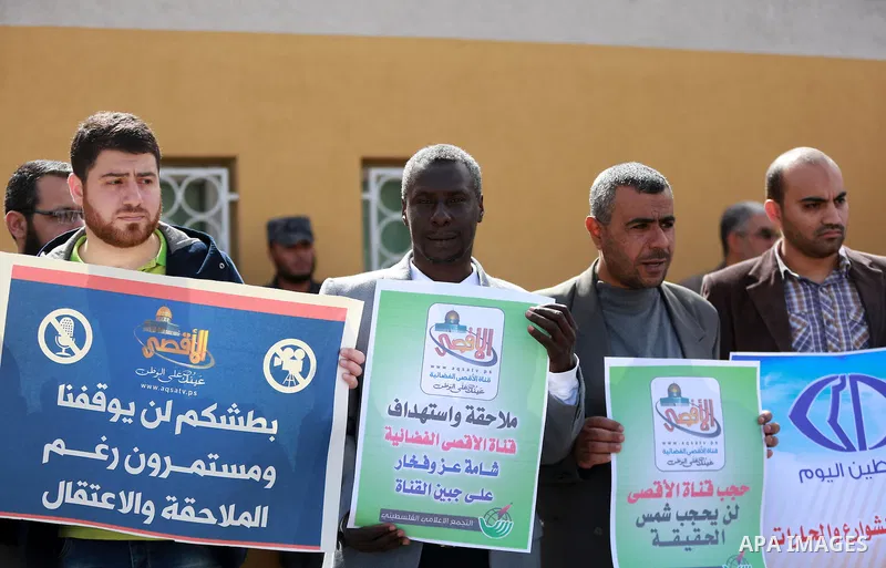 Palestinian journalists hold placards during a protest to solidarity with al-Aqsa TV channel which it removing from EUTELSAT, in Gaza City on March 14, 2016. Israeli Prime Minister Benjamin Netanyahu said Sunday that Isr...