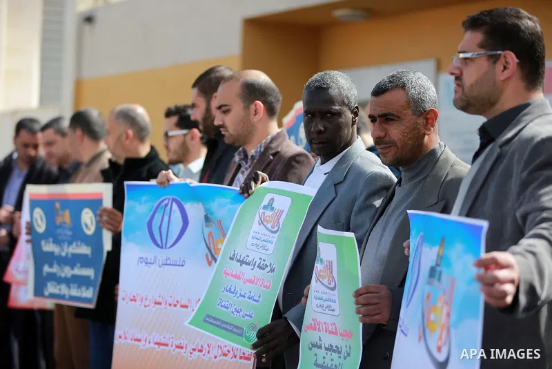 Palestinian journalists hold placards during a protest to solidarity with al-Aqsa TV channel which it removing from EUTELSAT, in Gaza City on March 14, 2016. Israeli Prime Minister Benjamin Netanyahu said Sunday that Isr...