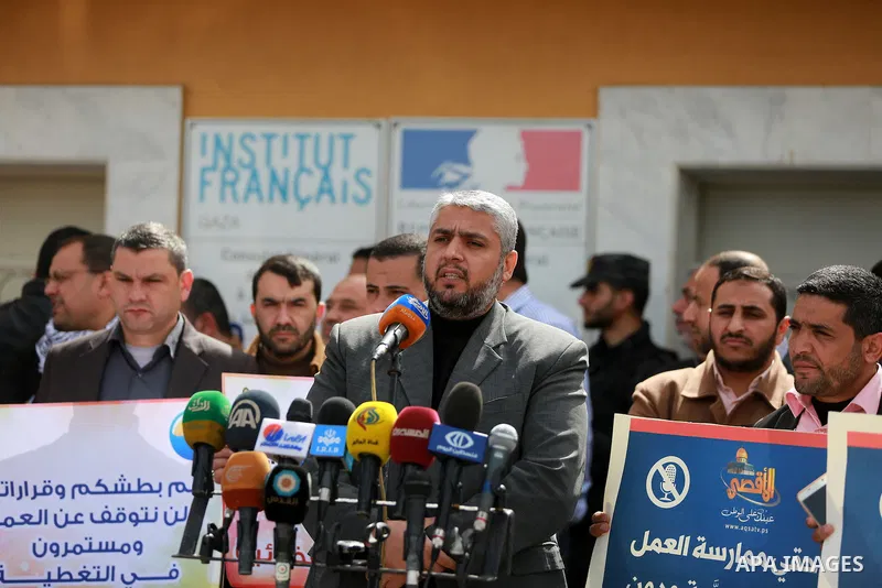 Palestinian journalists hold placards during a protest to solidarity with al-Aqsa TV channel which it removing from EUTELSAT, in Gaza City on March 14, 2016. Israeli Prime Minister Benjamin Netanyahu said Sunday that Isr...