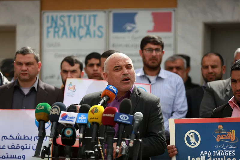 Palestinian journalists hold placards during a protest to solidarity with al-Aqsa TV channel which it removing from EUTELSAT, in Gaza City on March 14, 2016. Israeli Prime Minister Benjamin Netanyahu said Sunday that Isr...