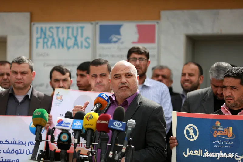 Palestinian journalists hold placards during a protest to solidarity with al-Aqsa TV channel which it removing from EUTELSAT, in Gaza City on March 14, 2016. Israeli Prime Minister Benjamin Netanyahu said Sunday that Isr...
