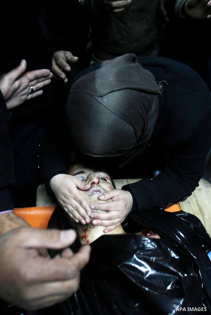 The sister of Palestinian Yousef Tarayra, 18, who the Israeli military said was shot dead by the Israeli army after he carried out an attack on Israelis, mourns around his body in a hospital in the West Bank city of Hebr...