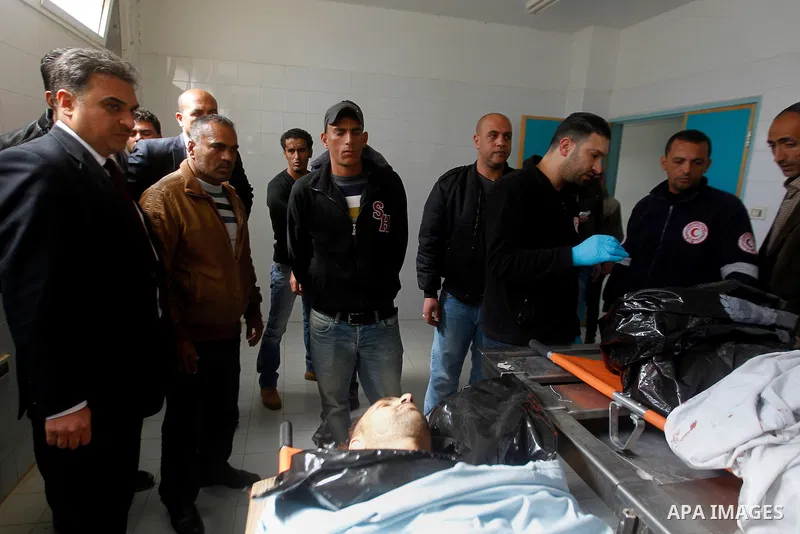 Mourners gather around the bodies of Palestinians, who the Israeli military said were shot dead by the Israeli army after they carried out attacks on Israelis, in a hospital in the West Bank city of Hebron March 14, 2016...