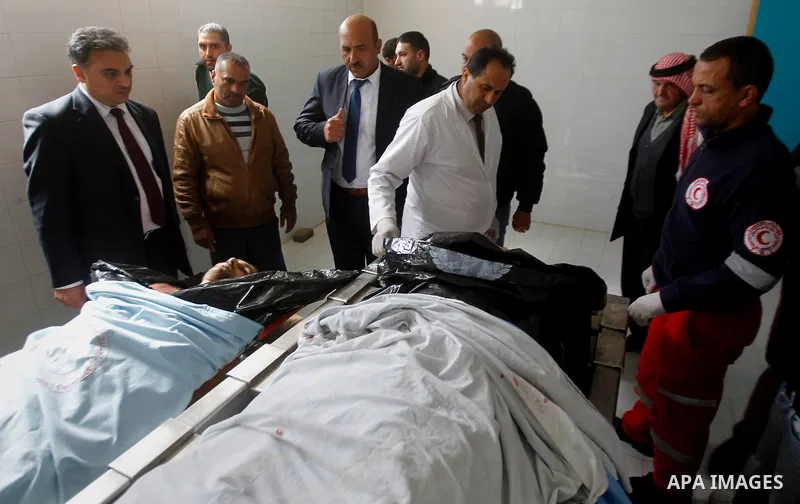 Mourners gather around the bodies of Palestinians, who the Israeli military said were shot dead by the Israeli army after they carried out attacks on Israelis, in a hospital in the West Bank city of Hebron March 14, 2016...