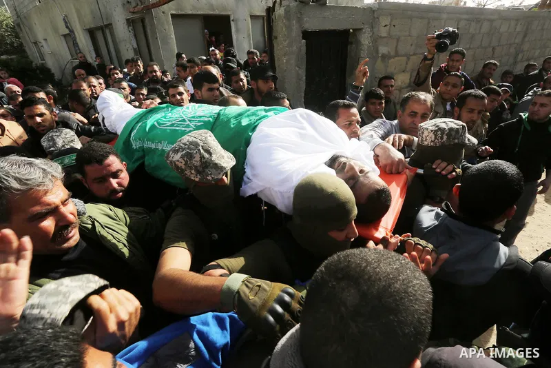Palestinian members of the Ezzedine al-Qassam Brigades, the armed wing of the Hamas movement carry the body of their comrade Abdel Salam Al-Batniji, 36, during his funeral Gaza city, on March 14, 2016. A Gaza tunnel coll...