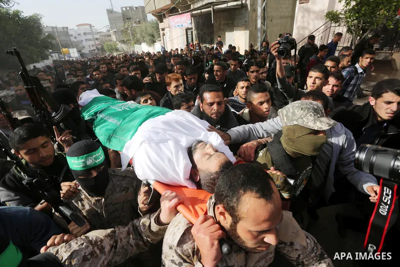 Palestinian members of the Ezzedine al-Qassam Brigades, the armed wing of the Hamas movement carry the body of their comrade Abdel Salam Al-Batniji, 36, during his funeral Gaza city, on March 14, 2016. A Gaza tunnel coll...