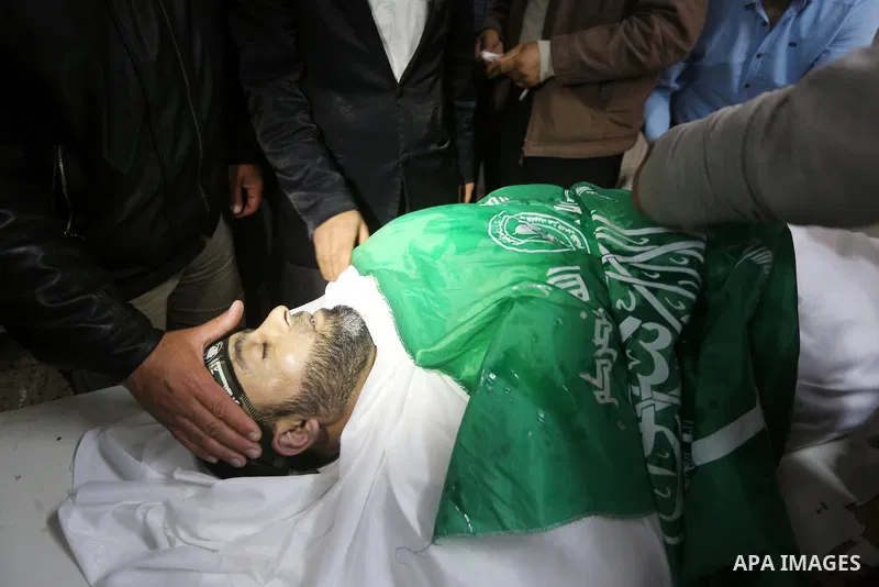 Palestinians mourn around the body of Ezzedine al-Qassam Brigades member Abdel Salam Al-Batniji, 36, during his funeral Gaza city, on March 14, 2016. A Gaza tunnel collapsed in Shujaiyyeh, in the eastern part of Gaza cit...