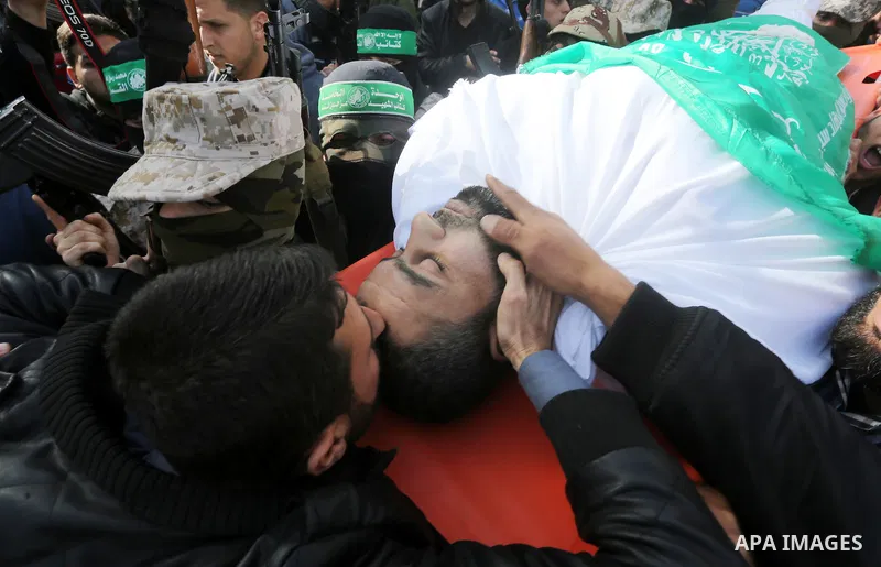 Mourners carry the body of Ezzedine al-Qassam Brigades member Abdel Salam Al-Batniji, 36, during his funeral Gaza city, on March 14, 2016. A Gaza tunnel collapsed in Shujaiyyeh, in the eastern part of Gaza city on Monday...