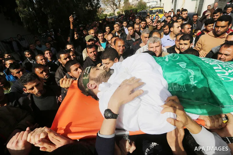 Mourners carry the body of Ezzedine al-Qassam Brigades member Abdel Salam Al-Batniji, 36, during his funeral Gaza city, on March 14, 2016. A Gaza tunnel collapsed in Shujaiyyeh, in the eastern part of Gaza city on Monday...