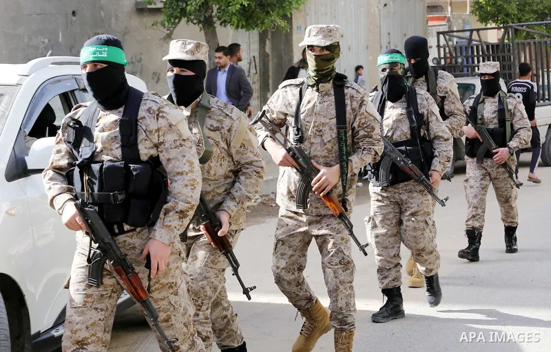 Palestinian members of the Ezzedine al-Qassam Brigades, the armed wing of the Hamas movement take part in the funeral of their comrade Abdel Salam Al-Batniji, 36, in Gaza city, on March 14, 2016. A Gaza tunnel collapsed...