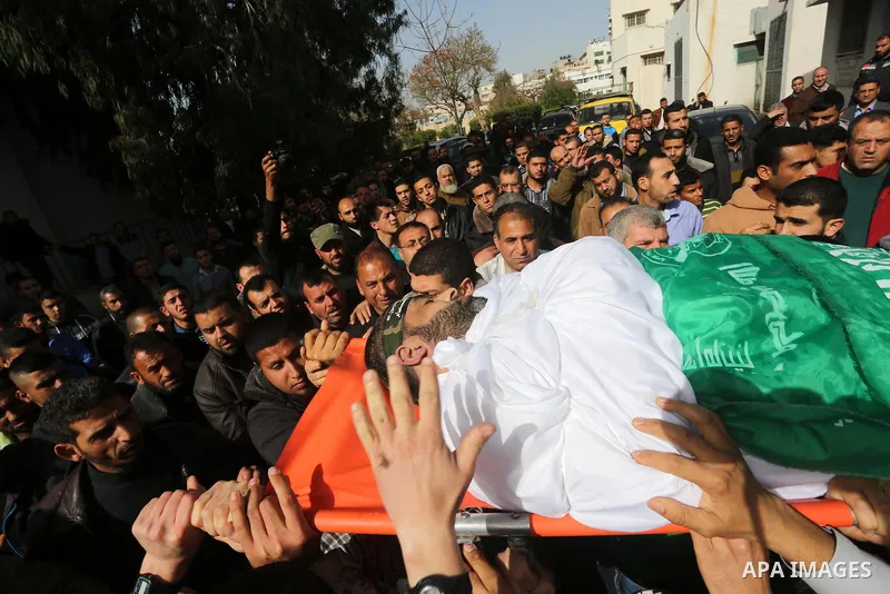 Mourners carry the body of Ezzedine al-Qassam Brigades member Abdel Salam Al-Batniji, 36, during his funeral Gaza city, on March 14, 2016. A Gaza tunnel collapsed in Shujaiyyeh, in the eastern part of Gaza city on Monday...