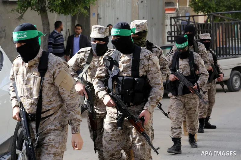 Palestinian members of the Ezzedine al-Qassam Brigades, the armed wing of the Hamas movement take part in the funeral of their comrade Abdel Salam Al-Batniji, 36, in Gaza city, on March 14, 2016. A Gaza tunnel collapsed...