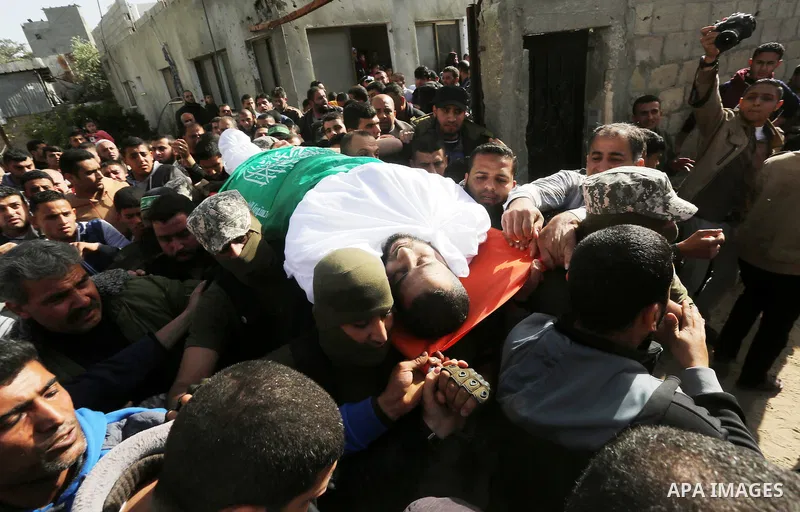 Palestinian members of the Ezzedine al-Qassam Brigades, the armed wing of the Hamas movement carry the body of their comrade Abdel Salam Al-Batniji, 36, during his funeral Gaza city, on March 14, 2016. A Gaza tunnel coll...