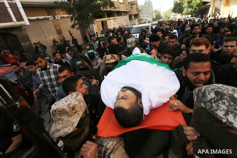 Palestinian members of the Ezzedine al-Qassam Brigades, the armed wing of the Hamas movement carry the body of their comrade Abdel Salam Al-Batniji, 36, during his funeral Gaza city, on March 14, 2016. A Gaza tunnel coll...
