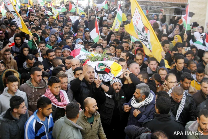 Mourners carry the body of Palestinian Yousef Tarayra, 18, who the Israeli military said was shot dead by the Israeli army after he carried out an attack on Israelis, during his funeral in the West Bank village of Bani N...