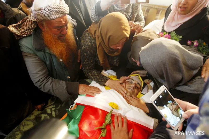 Relatives of Palestinian Yousef Tarayra, 18, who the Israeli military said was shot dead by the Israeli army after he carried out an attack on Israelis, mourn during his funeral in the West Bank village of Bani Na'im nea...