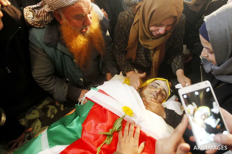 Relatives of Palestinian Yousef Tarayra, 18, who the Israeli military said was shot dead by the Israeli army after he carried out an attack on Israelis, mourn during his funeral in the West Bank village of Bani Na'im nea...