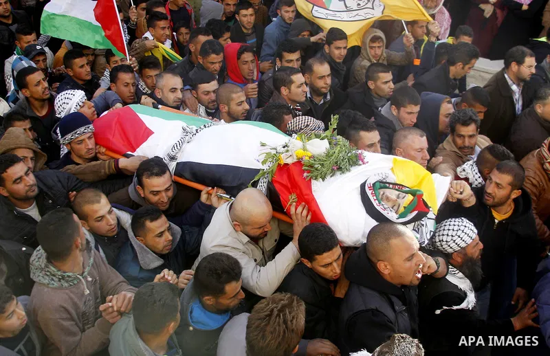 Mourners carry the body of Palestinian Yousef Tarayra, 18, who the Israeli military said was shot dead by the Israeli army after he carried out an attack on Israelis, during his funeral in the West Bank village of Bani N...