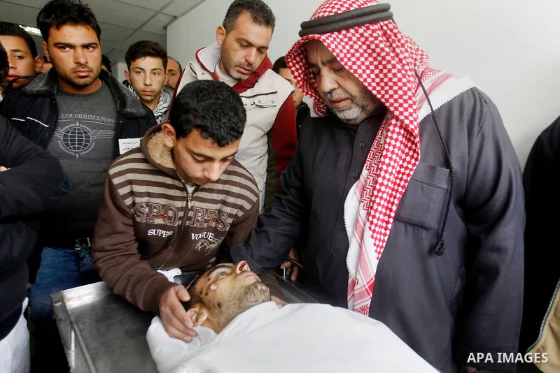 Relatives of Amir Juneidi, a Palestinian who was shot dead following reported attacks on Israelis, mourn during his funeral on March 15, 2016 in the West Bank town of Hebron. Three Palestinians, Qassem Jaber, 30, and Ami...