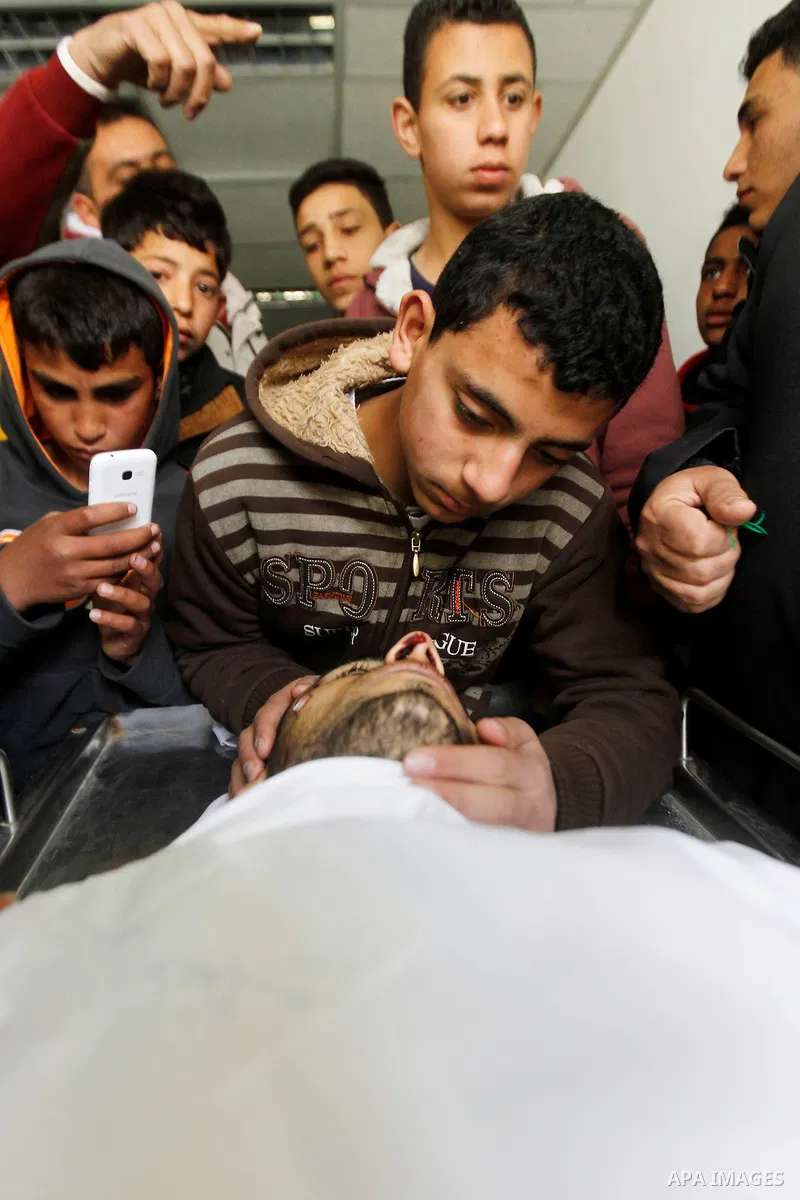 Relatives of Amir Juneidi, a Palestinian who was shot dead following reported attacks on Israelis, mourn during his funeral on March 15, 2016 in the West Bank town of Hebron. Three Palestinians, Qassem Jaber, 30, and Ami...