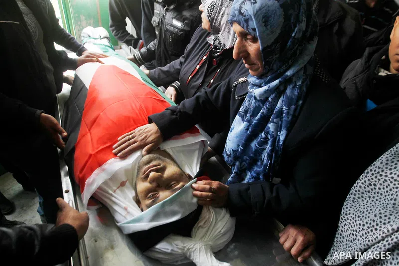 The mother of Qassem Jaber, a Palestinian who was shot dead following reported attacks on Israelis, mourn during his funeral on March 15, 2016 in the West Bank town of Hebron. Three Palestinians, Qassem Jaber, 30, and Am...
