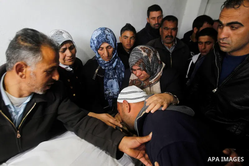 Relatives of Qassem Jaber, a Palestinian who was shot dead following reported attacks on Israelis, mourn during his funeral on March 15, 2016 in the West Bank town of Hebron. Three Palestinians, Qassem Jaber, 30, and Ami...