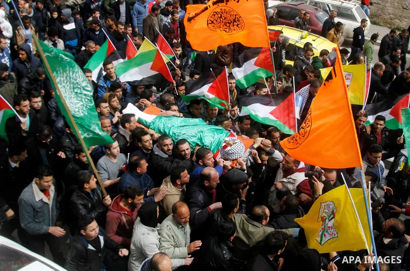 Mourners carry the body of Amir Juneidi, a Palestinian who was shot dead following reported attacks on Israelis, during his funeral on March 15, 2016 in the West Bank town of Hebron. Three Palestinians, Qassem Jaber, 30,...