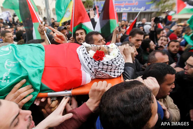 Mourners carry the body of Amir Juneidi, a Palestinian who was shot dead following reported attacks on Israelis, during his funeral on March 15, 2016 in the West Bank town of Hebron. Three Palestinians, Qassem Jaber, 30,...