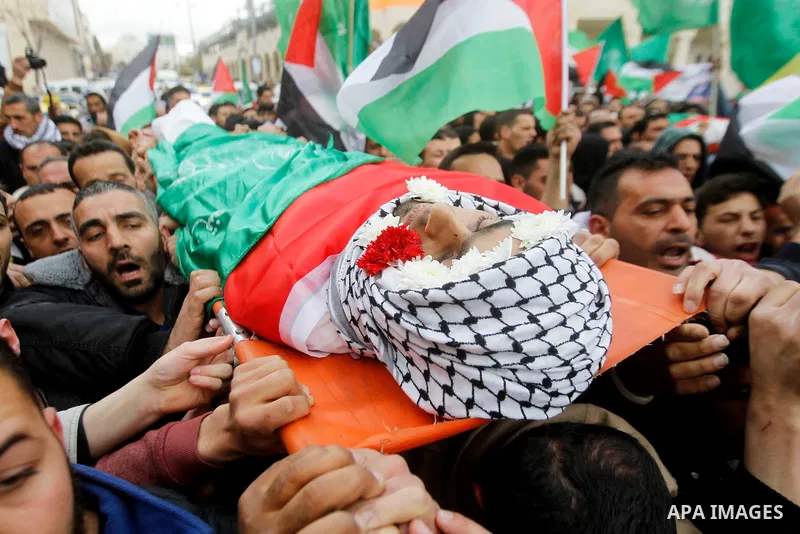 Mourners carry the body of Amir Juneidi, a Palestinian who was shot dead following reported attacks on Israelis, during his funeral on March 15, 2016 in the West Bank town of Hebron. Three Palestinians, Qassem Jaber, 30,...