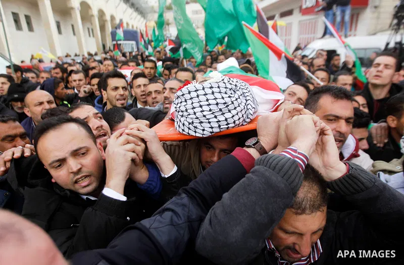 Mourners carry the body of Amir Juneidi, a Palestinian who was shot dead following reported attacks on Israelis, during his funeral on March 15, 2016 in the West Bank town of Hebron. Three Palestinians, Qassem Jaber, 30,...