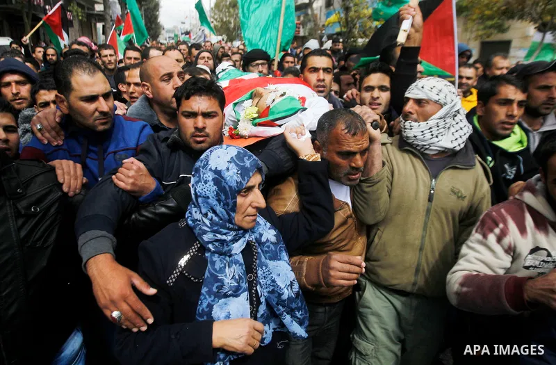 Mourners carry the body of Qassem Jaber, a Palestinian who was shot dead following reported attacks on Israelis, during his funeral on March 15, 2016 in the West Bank town of Hebron. Three Palestinians, Qassem Jaber, 30,...