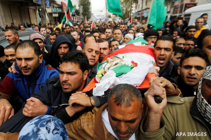 Mourners carry the body of Qassem Jaber, a Palestinian who was shot dead following reported attacks on Israelis, during his funeral on March 15, 2016 in the West Bank town of Hebron. Three Palestinians, Qassem Jaber, 30,...
