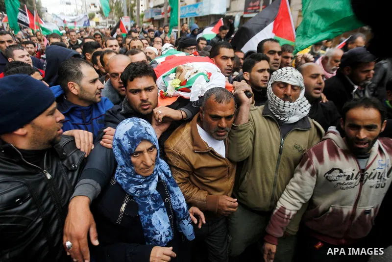 Mourners carry the body of Qassem Jaber, a Palestinian who was shot dead following reported attacks on Israelis, during his funeral on March 15, 2016 in the West Bank town of Hebron. Three Palestinians, Qassem Jaber, 30,...