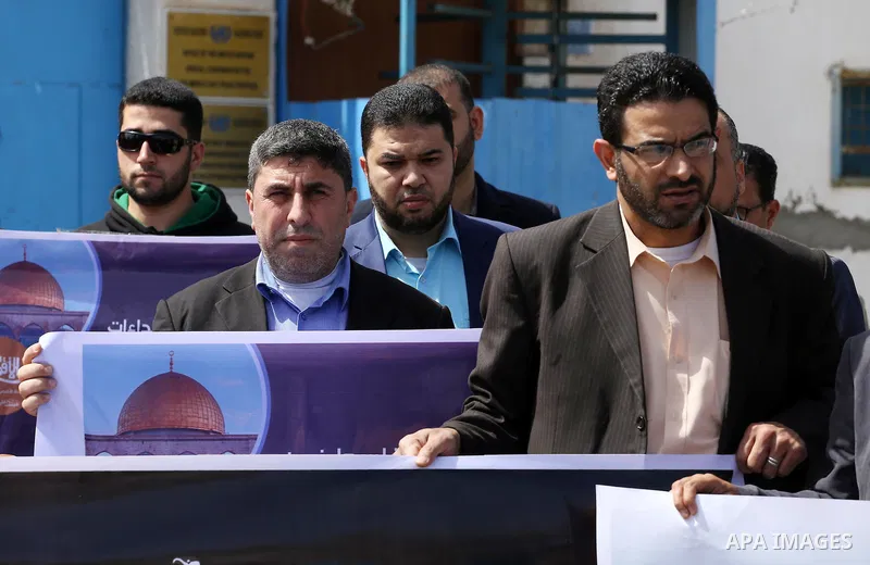 Palestinian employees of Al-Aqsa TV carry placards during a protest outside the United Nations Office in Gaza City on March 15, 2016, against the decision to halt transmission of the channel by the French satellite Eutel...