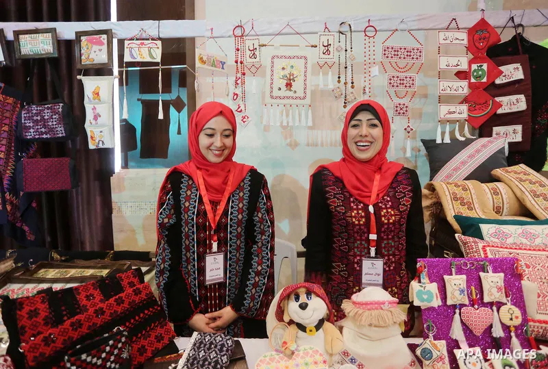 Palestinian women take part during Palestinian Heritage Exhibition on the theme ''Products of our women'', in Gaza City, on March 15, 2016. Photo by Mohammed Asad