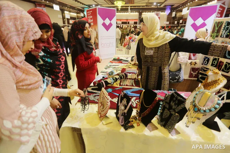 Palestinian women take part during Palestinian Heritage Exhibition on the theme ''Products of our women'', in Gaza City, on March 15, 2016. Photo by Mohammed Asad