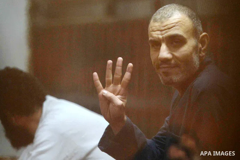 Defendants of Egyptian Muslim Brotherhood sit behind bars during the 'Qatar espionage' case, in a court in Cairo on March 15, 2016. The defendants are accused of 'leaking important national security documents and informa...